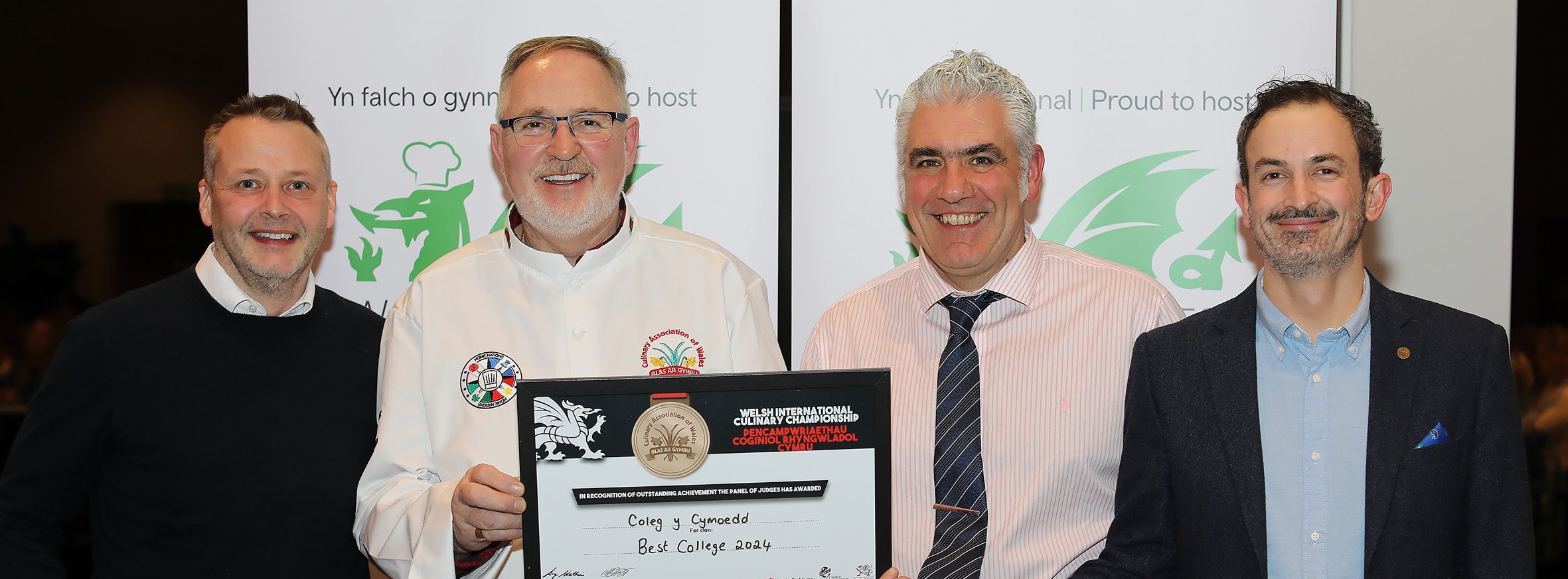 Culinary Association of Wales president Arwyn Watkins, OBE, presents the best college award to Coleg y Cymoedd assistant head of school Ian Presgrave and catering and hospitality lecturers Kevin Hall and Max Vian.